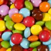 assorted color candies on brown wooden table